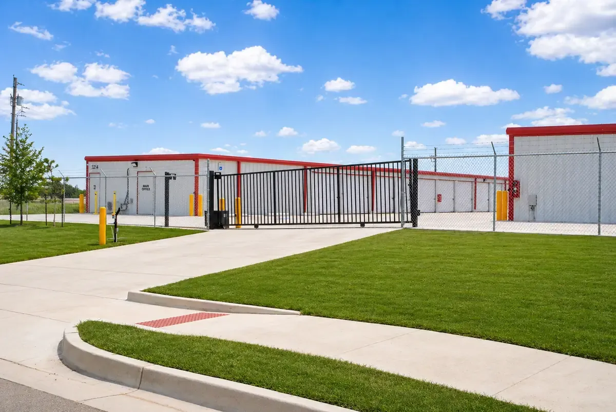 Outside view of storage facility with gate and keypad at front